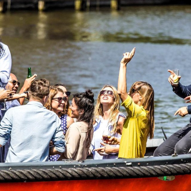 a group of people in a boat on a body of water