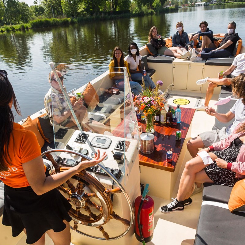 a group of people sitting in a boat on a body of water