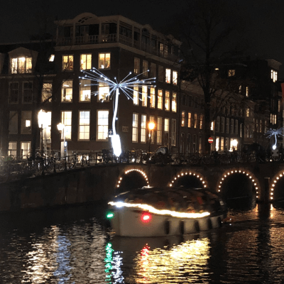 a bridge over water with a city in the background